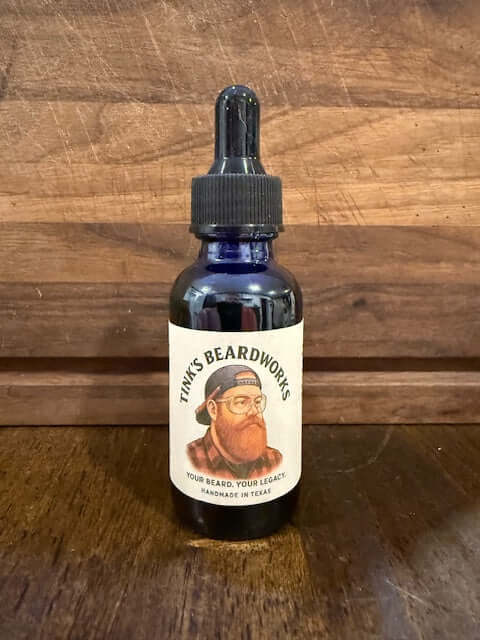 The Lumberjack "Premium Beard Oil - Woods Blend 1oz" bottle by Tink's Beardworks on a wooden background.